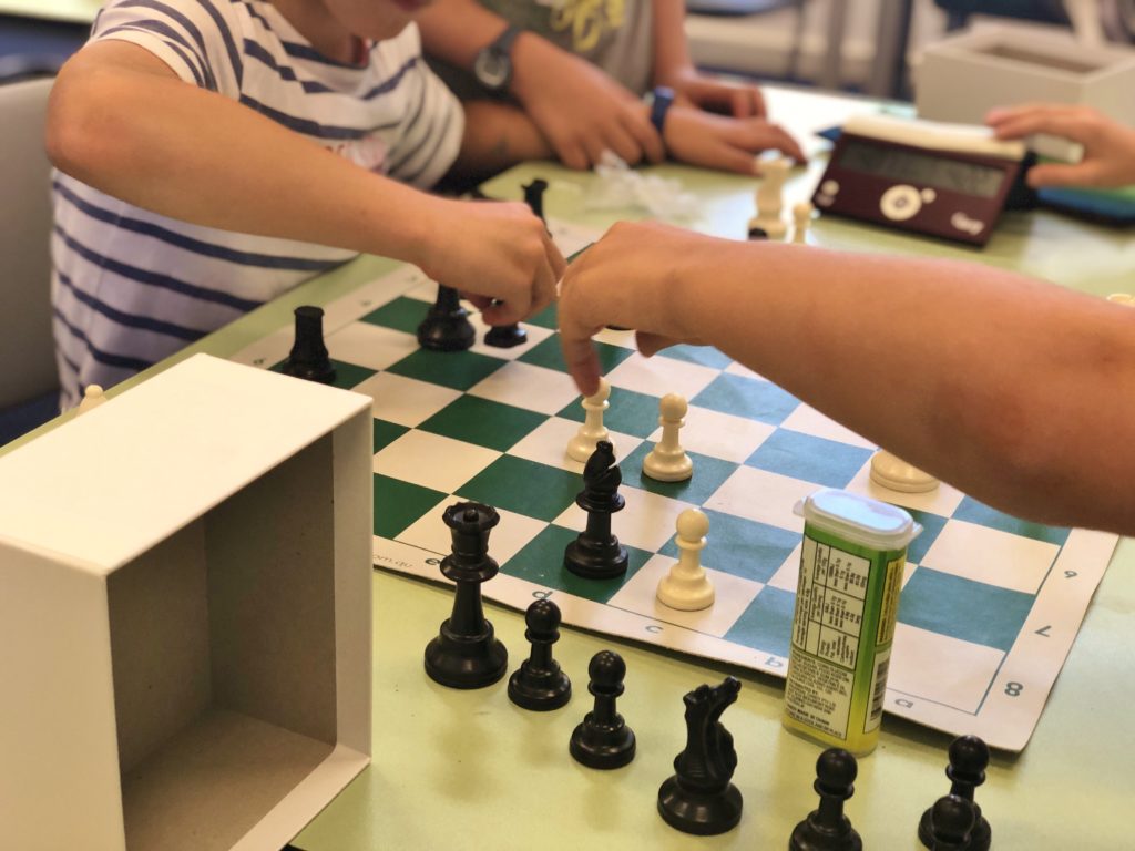 Young students playing chess in their after school chess club